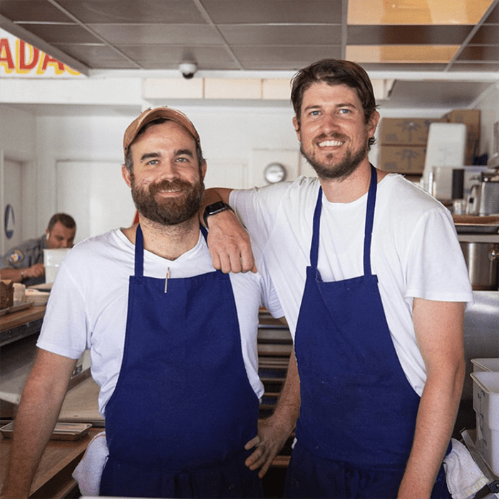 Chef's Jordan & Alex Posing For A Picture In A Restaurant