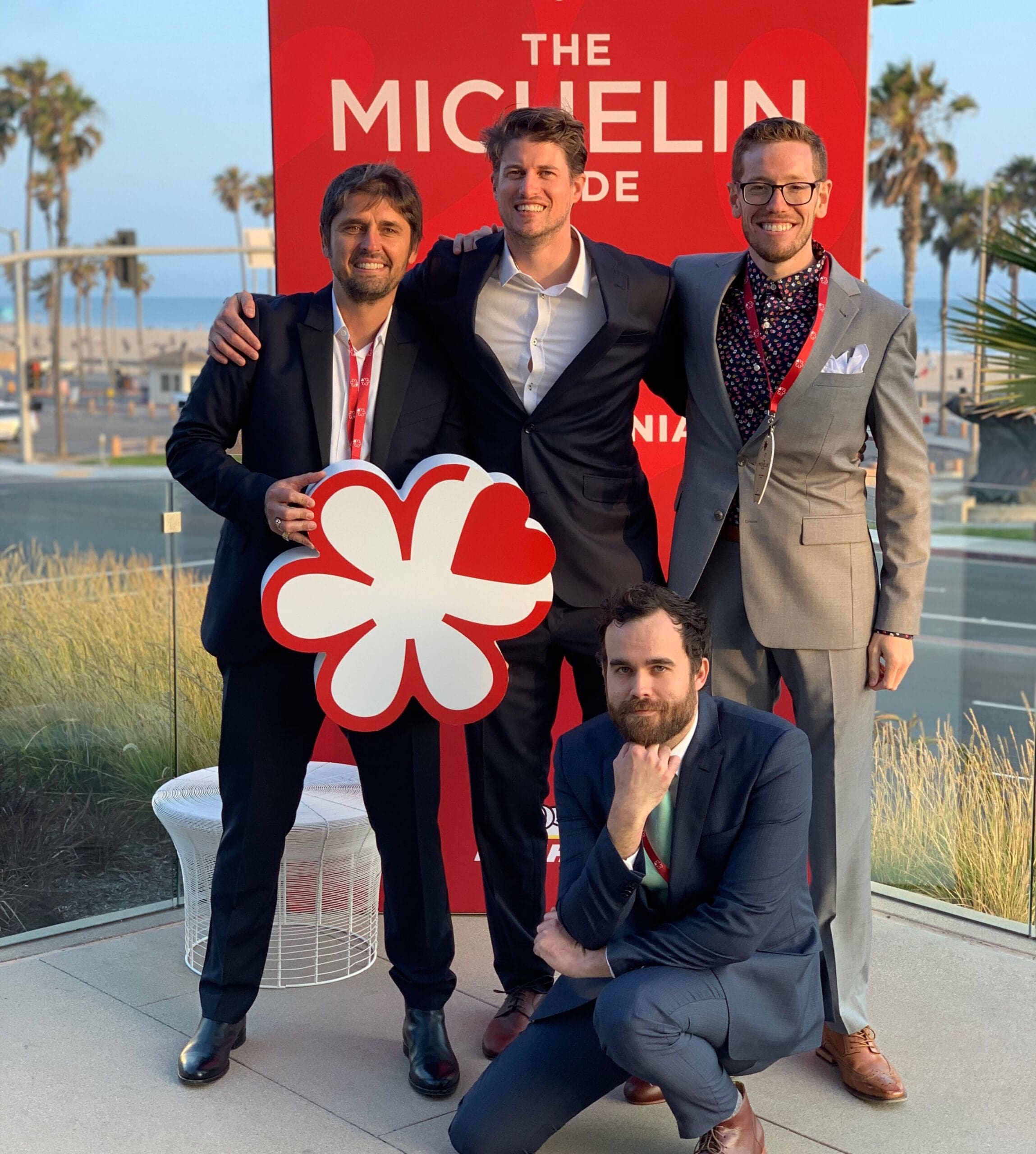 Image of Chefs Alex & Jordan alongside two other colleagues at Trois Mec in front of a Michelin sign